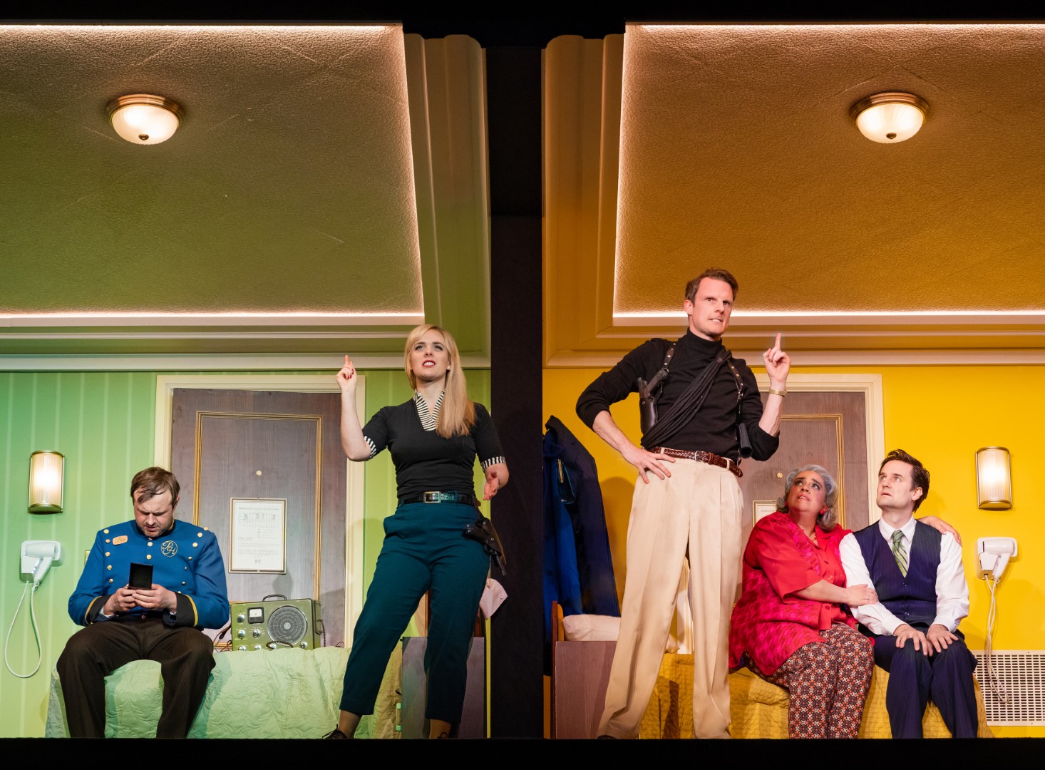 Split-scene of two hotel rooms: Charlie Russell and Chris Leask stand tensely in green room, while Dave Hearn, Nancy Zamit and Henry Shields pose dramatically in the yellow room
