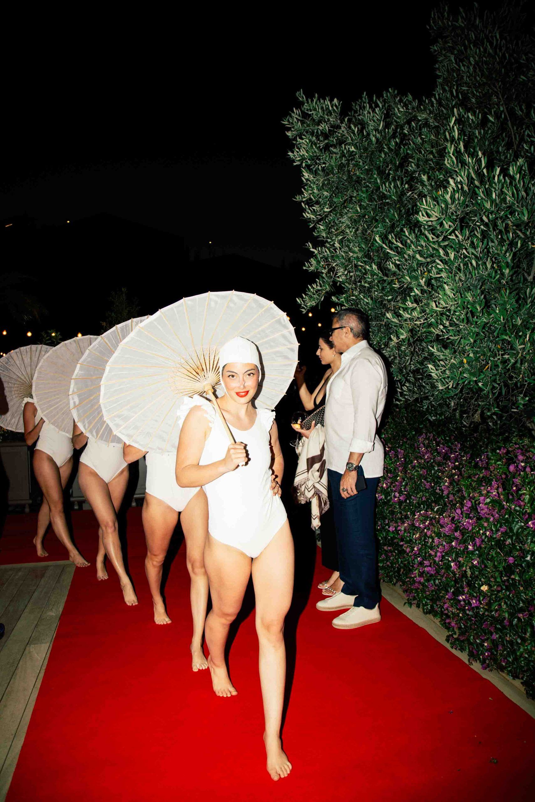 Synchronised swimmers walking on red carpet at Bodrum Edition Hotel