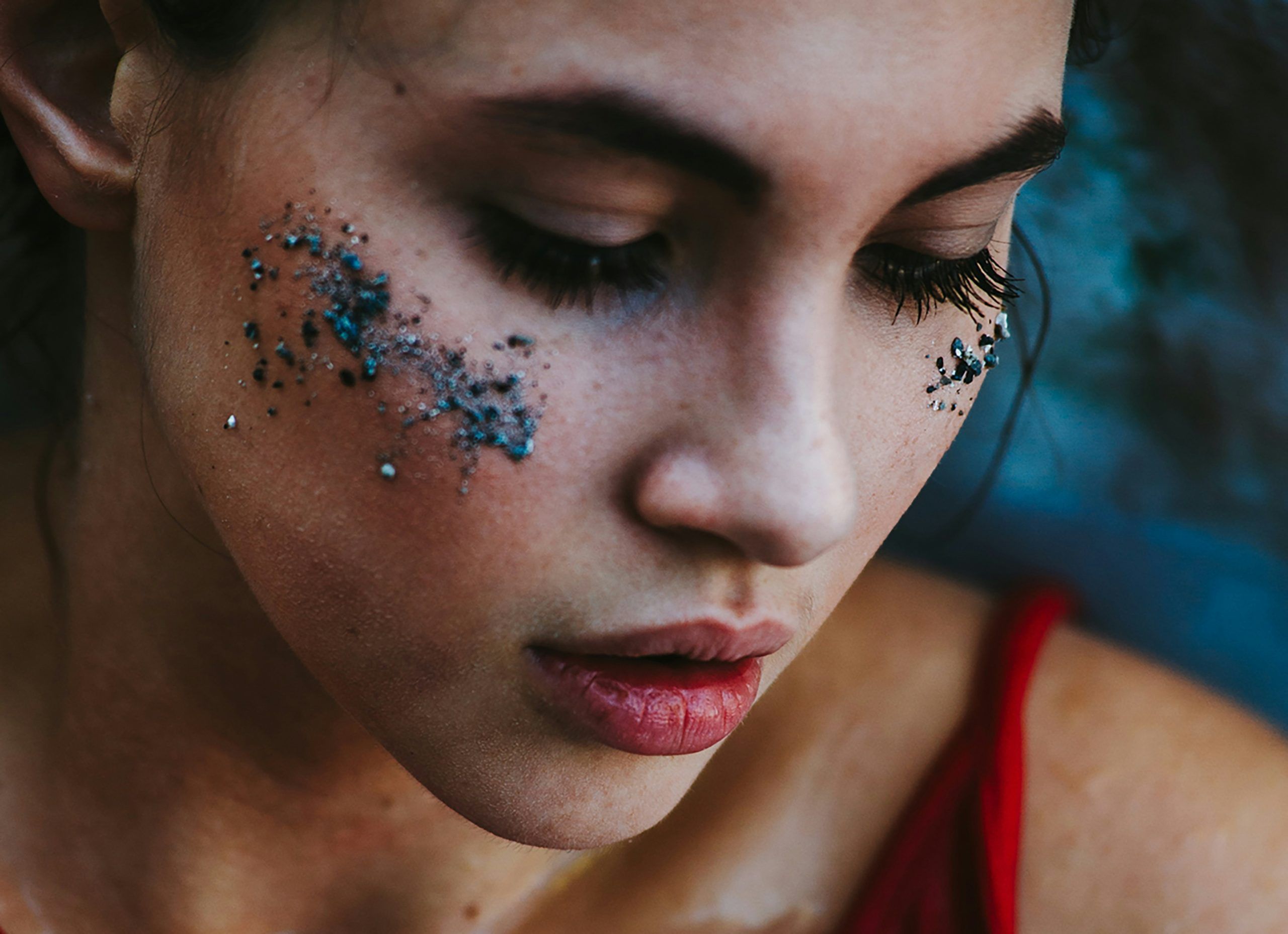 young woman with glitter on face