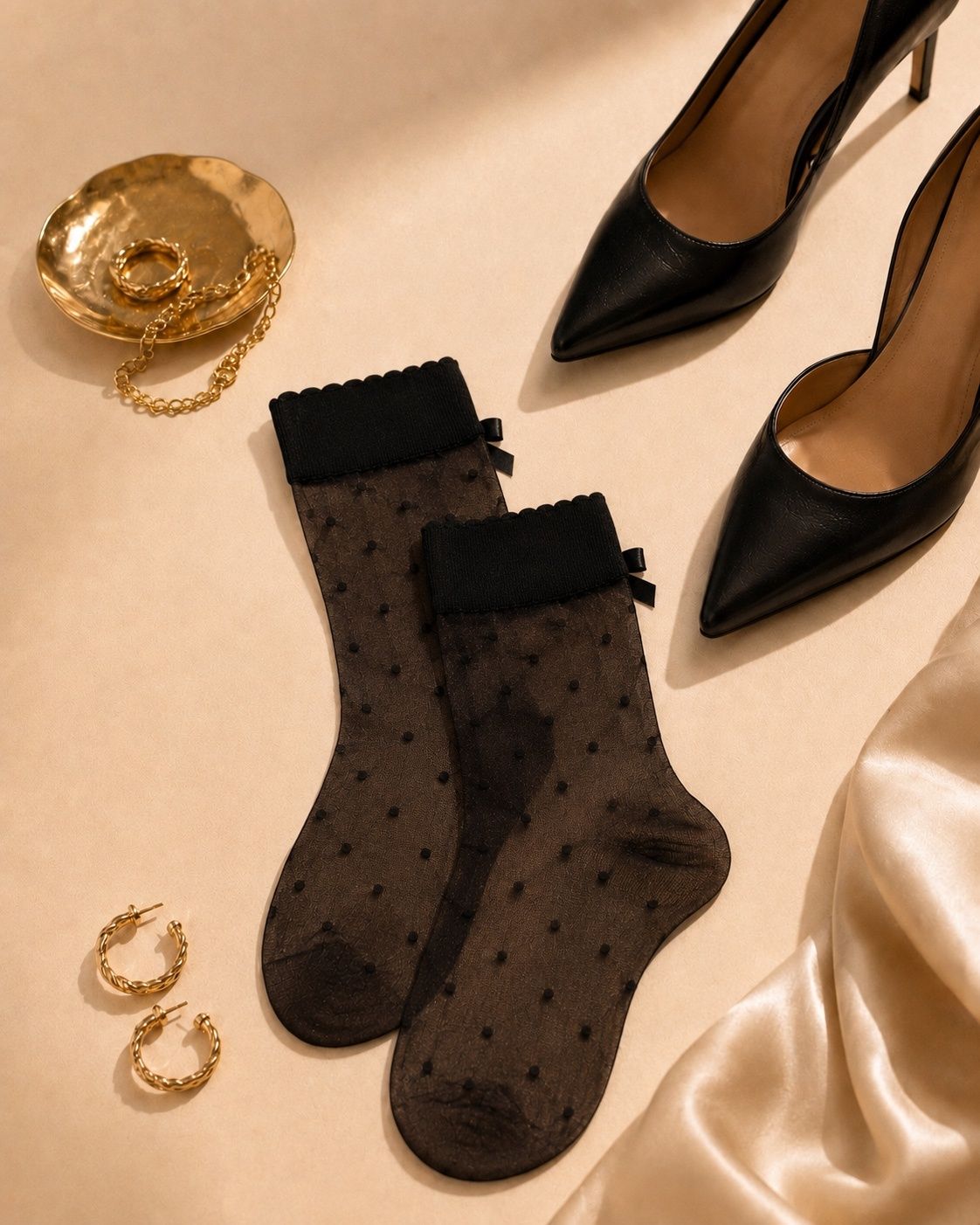 Close up of sheer black polka dot uniq ankle socks with bow accents worn with black pointed high heels