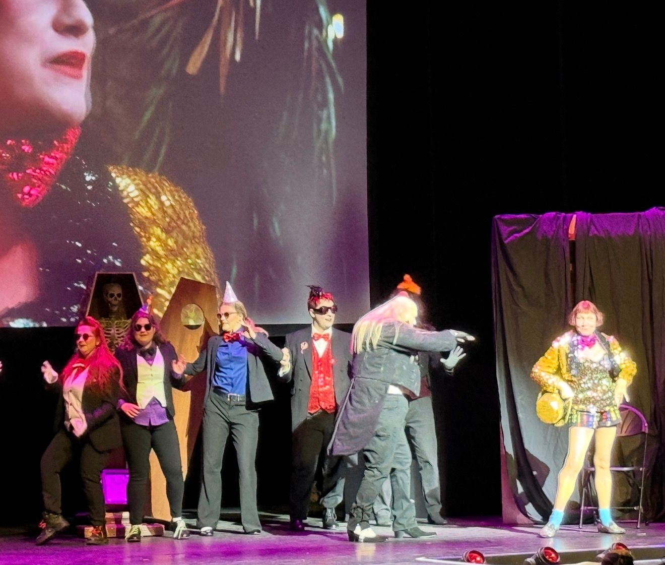 Rocky Horror shadow cast performing in front of the cinema screen