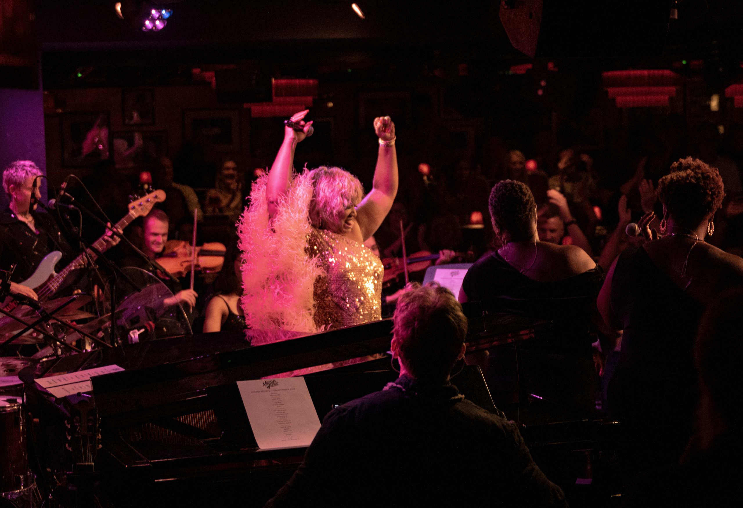 Marisha Wallace raising both arms during her Ronnie Scott’s performance